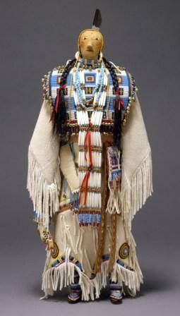 Joyce Growing Thunder (Assiniboine/Sioux, b. 1950) Fort Peck Reservation, Montana Female Doll, 2000 Cotton cloth, glass beads, commercial leather, metal bells, human hair, feather, ribbon, shell H. 19 ½ x W. 9 in. (49.5 x 22.9 cm) Ralph T. Coe Collection, Gift of the Ralph T. Coe Foundation for the Arts, 2011 (2011.154.196)